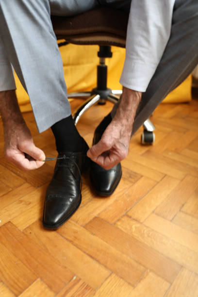 istock Senior businessman tying shoelaces 2162415854
