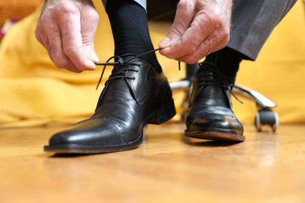 istock Senior businessman tying shoelaces 2162415856