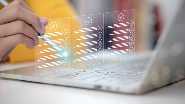 istock Women touching a virtual screen to tick mark documents for online approval. Prepare, check, and approve concepts. Document management is paperless, ensuring quality assurance and ERP management. 2162416682