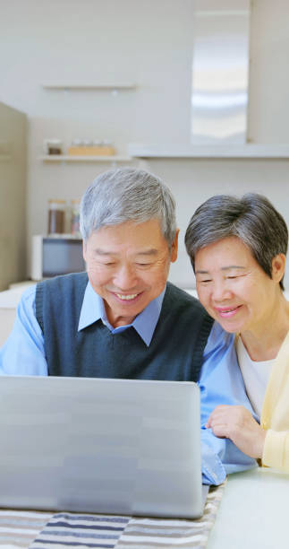 istock asian elderly couple use laptop 2162416939