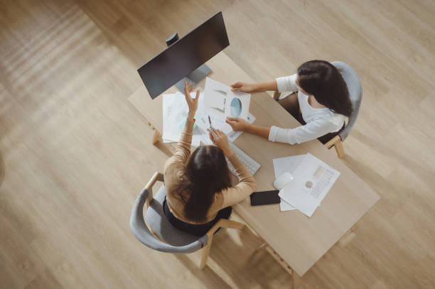 istock Top view of businessmen discussing work on work desks 2162418367