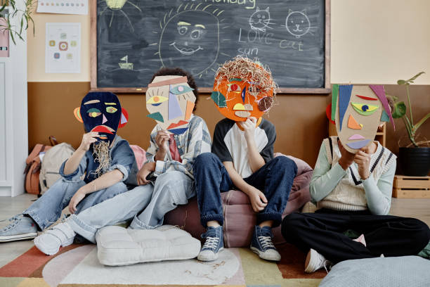 istock Kids Holding Handmade Masks in Class 2162419670