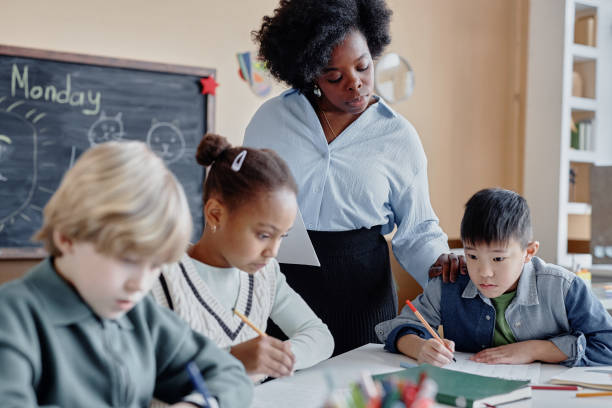 istock Individual Work of Primary Learners and Supportive Tutor 2162419674