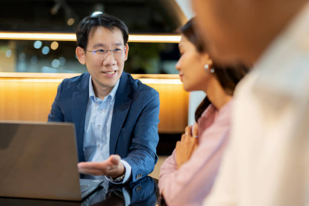 istock A financial or legal advisor is engaged in a discussion with a client, explaining the best strategies for investing in stocks to achieve good future returns. The conversation takes place in a modern office, emphasizing a professional environment. 2162422366