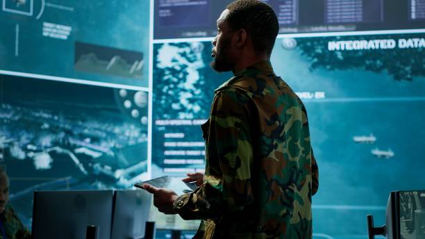 istock Cybersecurity specialist operates in a high tech military control center 2162425273