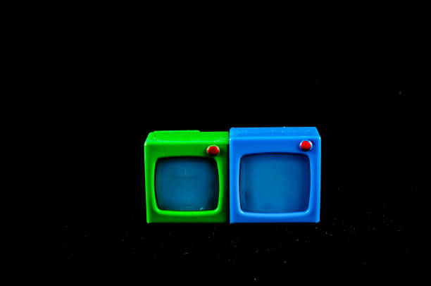 Two small televisions are shown side by side, one green and one blue. Concept of playfulness and fun