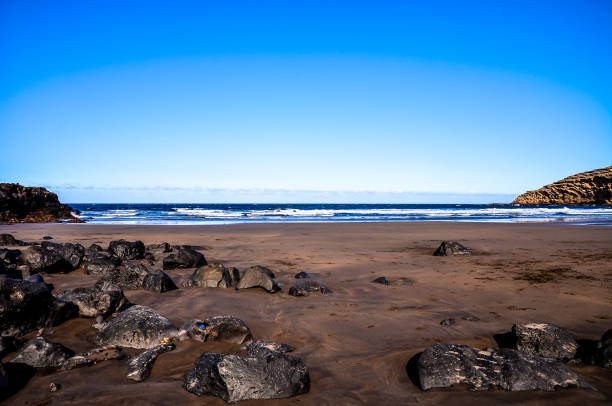 istock A beach with a rocky shoreline and a clear blue sky 2162425634