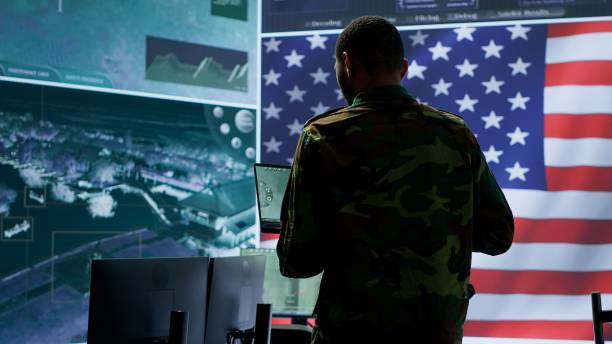 istock Professionals in US military uniforms operate computers and big screen 2162426753