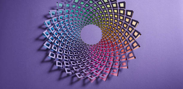 istock Intricate geometric paper art piece with a vibrant rainbow gradient spiral pattern set against a purple background. 2162426891