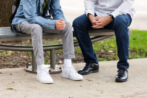 istock Unrecognizable dad has serious talk with teenage son 2162427293