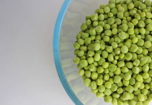 Transparent Bowl With Green Peas Preparing To Cooking Isolated On White