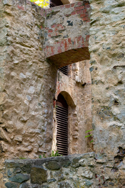 a stone wall has a window with a wooden frame