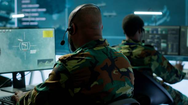 istock Military personnel in base of operations using advanced computers and big screen 2162427896