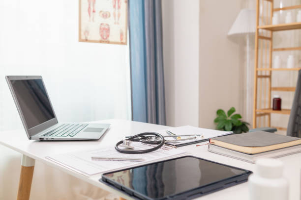 istock stethoscope is placed on work desk in doctor office After examining patient stethoscope is placed on the work desk to examine additional information from the computer that has compiled the results. 2162428027