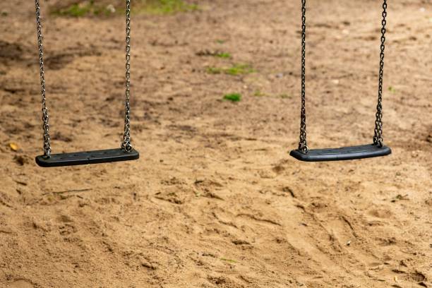 istock 2 swings on a children's playground 2162431074