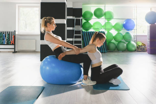 istock Women Exercise With Fitball In Gym 2162431273