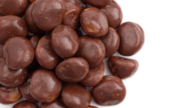 istock Chocolate Covered Caramel Disks Isolated on a White Background 2162440186