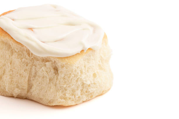 Frosted Homemade Bready Cinnamon Roll Buns Isolated on White Background