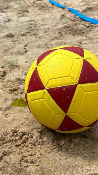 istock Ball in the sand with a butterfly. 2162440993