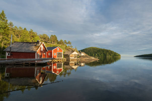 istock Red boathouses in the archipelago with water reflection 2162442756