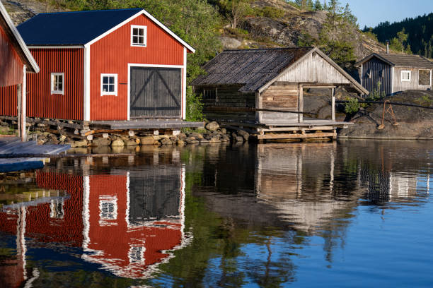 istock Red boathouses in the archipelago with water reflection 2162442785