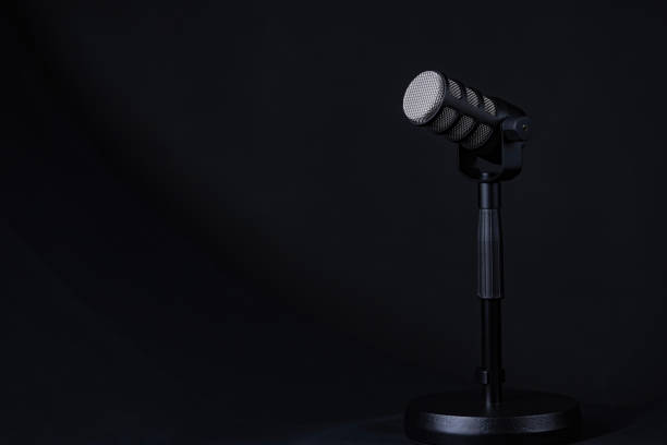 istock Podcast or voice recording microphone on a stand. Minimal lighting, dark background. Horizontal photo, copy space. 2162443153