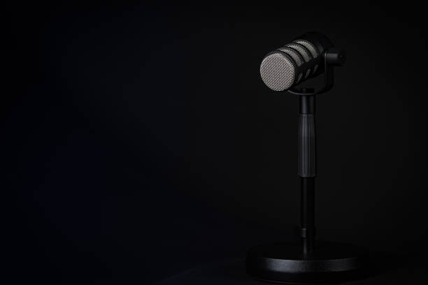istock Podcast or voice recording microphone on a stand. Minimal lighting, horizontal photo, copy space. 2162443554