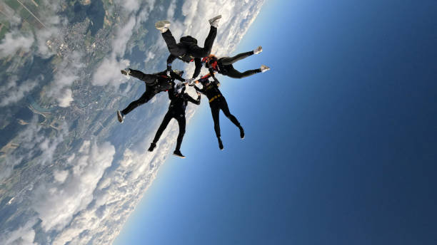 istock Freefall jumpers hold hands mid-air 2162443722