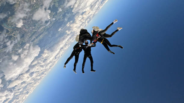 istock Freefall jumpers hold hands mid-air 2162443725