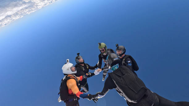 istock Freefall jumpers hold hands mid-air 2162443732