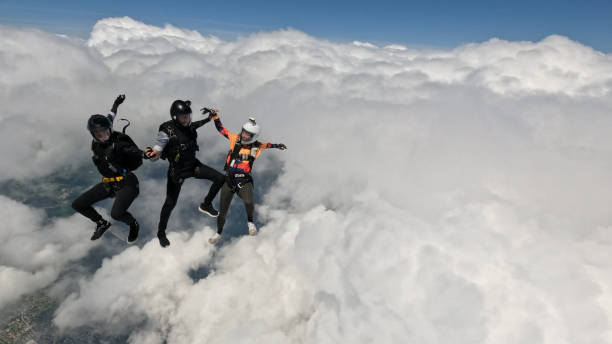 istock Freefall jumpers hold hands mid-air 2162443740
