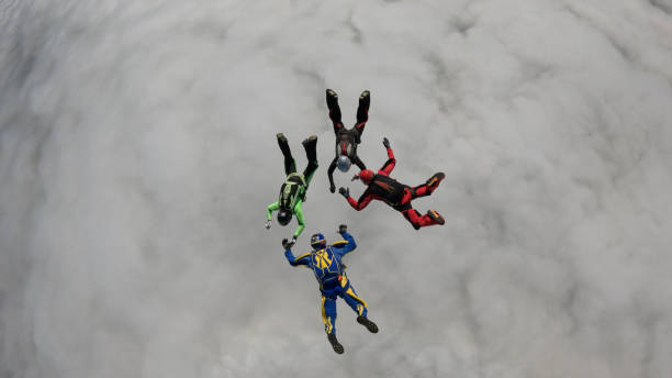 istock Freefall jumpers hold hands mid-air 2162443762