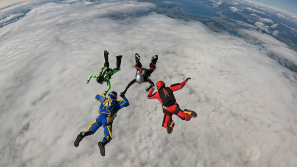 istock Freefall jumpers hold hands mid-air 2162443766