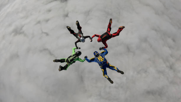 Freefall jumpers hold hands mid-air