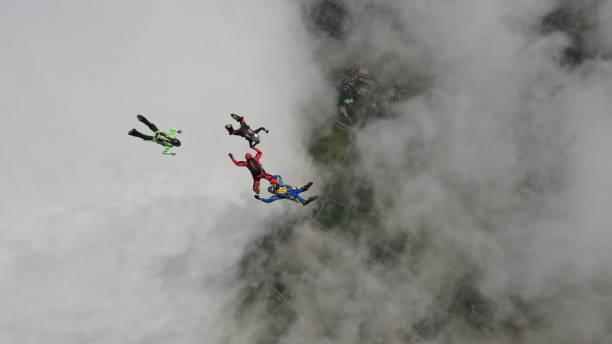 istock Freefall jumpers hold hands mid-air 2162443787