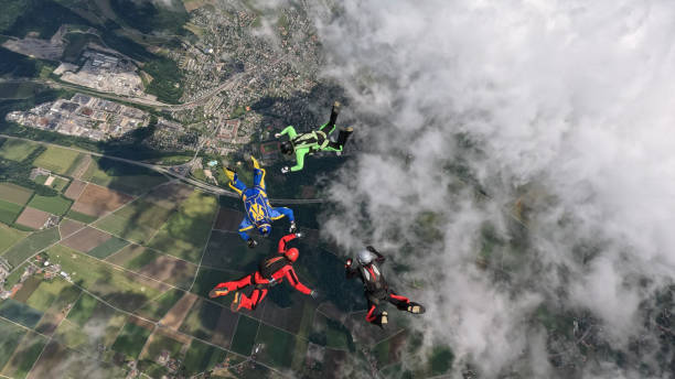 istock Freefall jumpers hold hands mid-air 2162443792