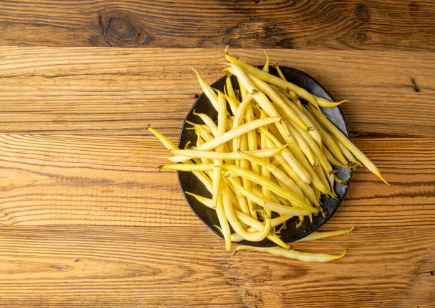Yellow French Beans on Rustic Wooden Table, Raw String Beans Pile, Fresh Wax Bean Pods on Vintage Retro Tabletop Background