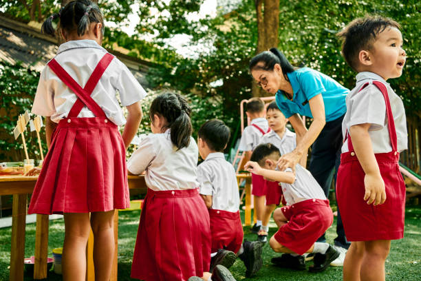 istock Students observing various flowers with a teacher at outdoor science class 2162446925