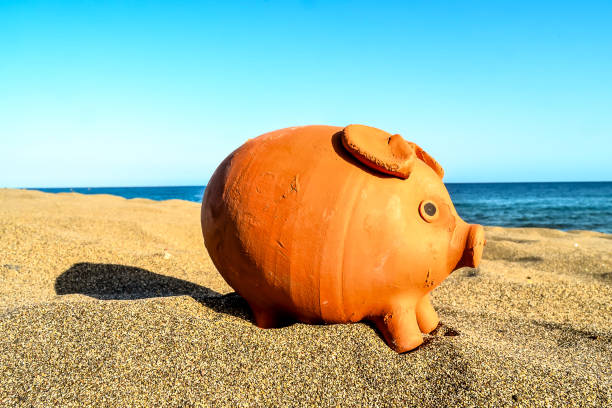 istock Piggy Bank on the Sand Beach 2162448346