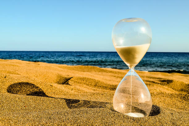 istock Hourglass Clock on the Sand Beach 2162448356