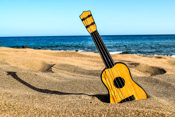 istock Guitar on the Sand Beach 2162448357
