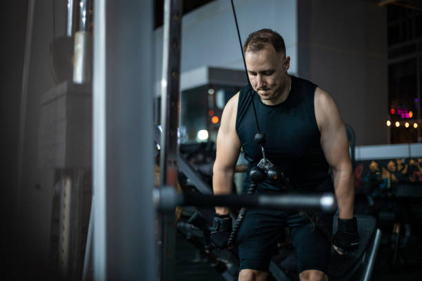 istock Man Working Out on a Cable Machine in a Gym 2162449338
