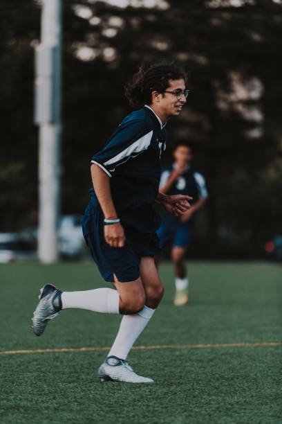 istock Young man runs on soccer field 2162449419