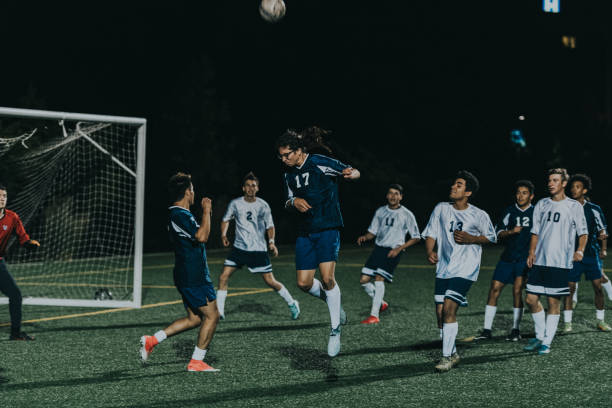 istock Young man heads a ball while playing soccer 2162449445