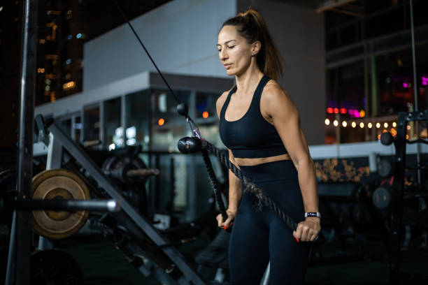 istock Woman Doing Cable Machine Row Exercise in Gym at Night 2162450268