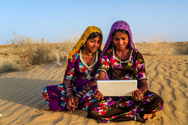 istock Happy Gypsy Indian girls using digital tablet, India 2162450321