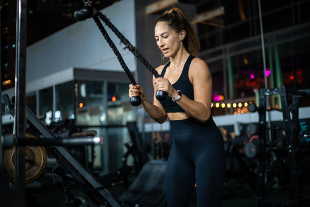 istock Woman Exercising With Cable Machine In Modern Gym 2162450396