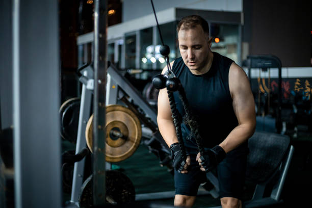 istock Man Working Out With Cable Machine in Gym 2162450897
