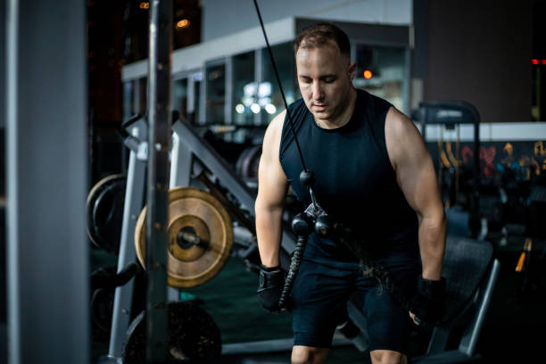 istock Man Working Out on Cable Machine in Gym 2162450912