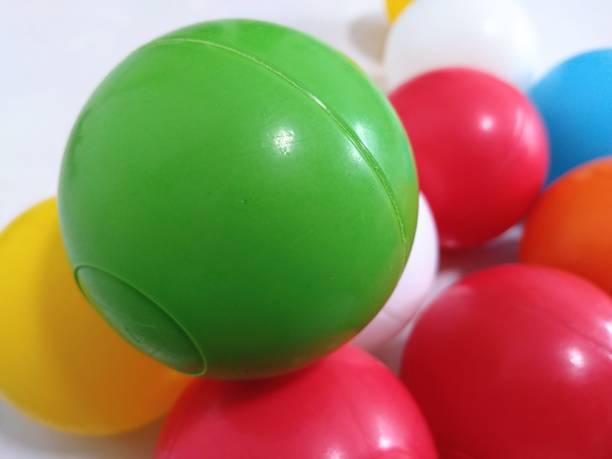 istock Colorful flying balls. Many multicolored balls flying over blue background 2162452723